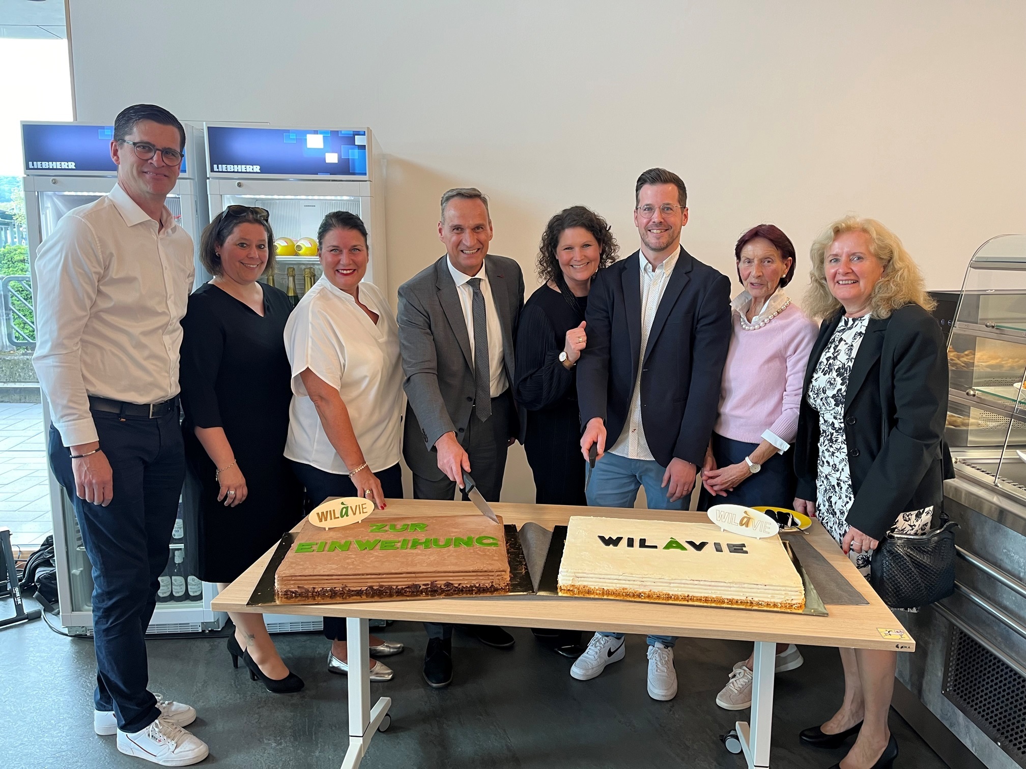 Das Foto zeigt Bürgermeister Rodenkirch mit Vertretern der Nutzungsgruppen des WILàvie bei Anschneiden eines Kuchen.