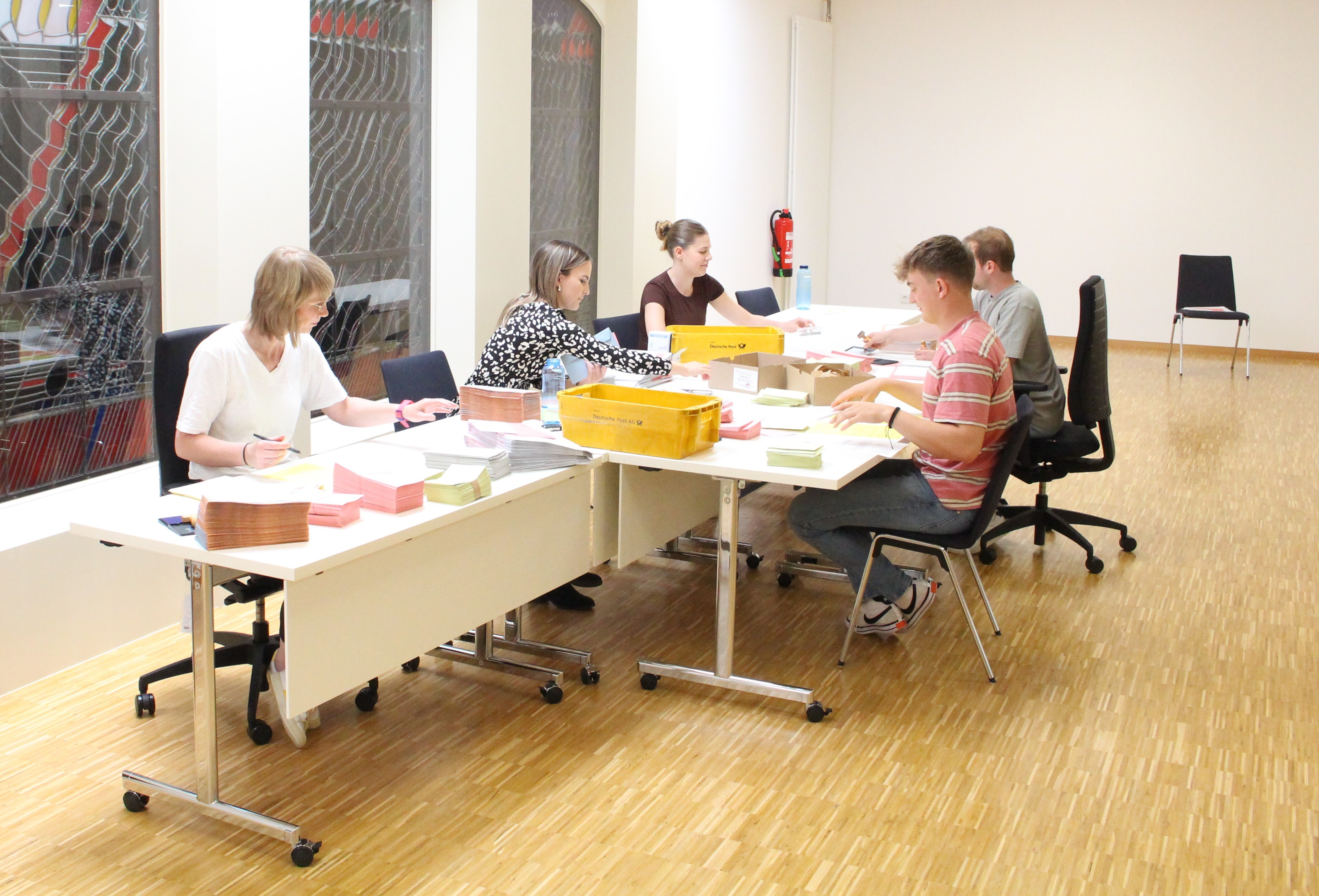 Das Foto zeigt Mitarbeiter der Verwaltung bei der Verpackung der Wahlunterlagen.